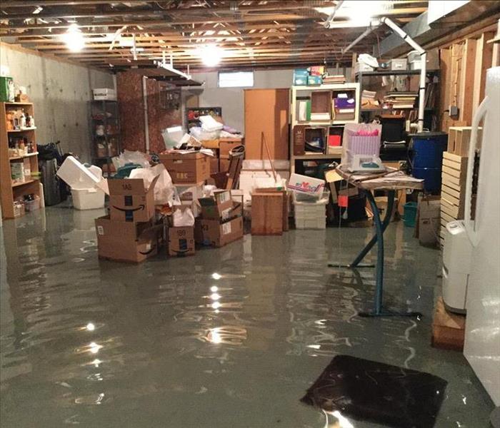 Flooded basement with many items affected by water